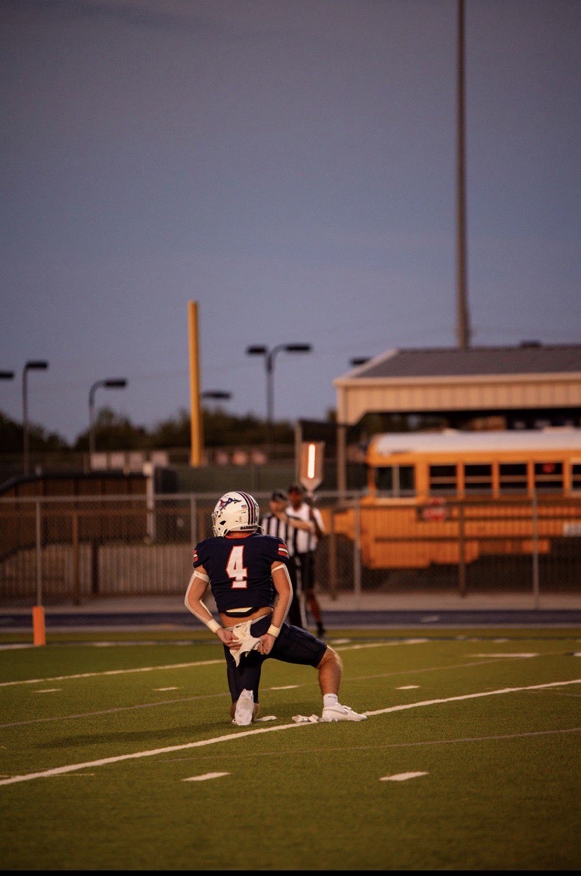 Carter Smith Class of 2027 taking a knee during a Madisonville High School football game